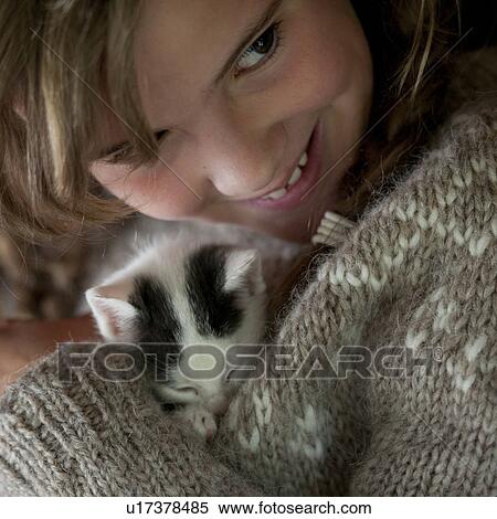 Stock Photography - Kitten cuddled by girl. Fotosearch