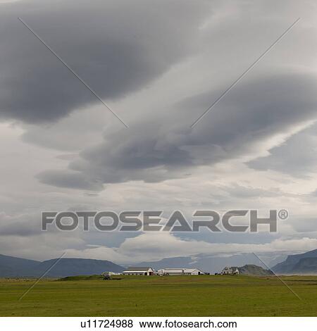 Landscape, cloudy sky over farmyard and distant mountain View Large Photo Image Stock Photo - Landscape, cloudy sky over farmyard and distant mountain. Fotosearch