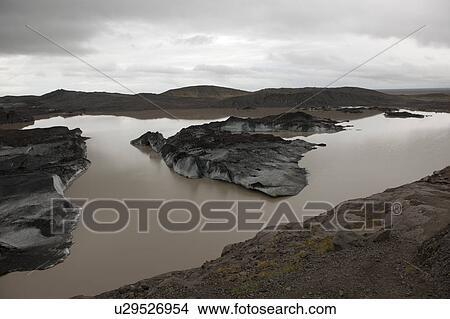 Picture - Landscape of dirty melting glaciers in a glacial lake. Fotosearch