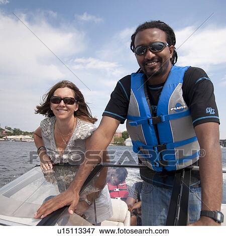 Stock Photo - Man and woman in a boat on Lake of the Woods, Ontario. Fotosearch