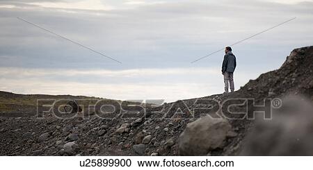 Man atop glacial moraine, rock and gravel debris View Large Photo Image Stock Image - Man atop glacial moraine, rock and gravel debris. Fotosearch