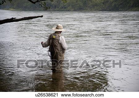 Man fly fishing at lake Taneycomo in Branson, Missouri View Large Photo Image Stock Image - Man fly fishing at lake Taneycomo in Branson, Missouri. Fotosearch