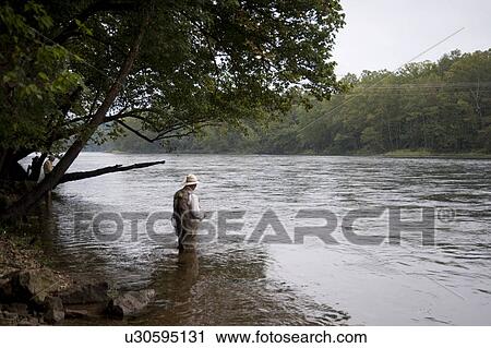 Man fly fishing at lake Taneycomo in Branson, Missouri View Large Photo Image Stock Image - Man fly fishing at lake Taneycomo in Branson, Missouri. Fotosearch
