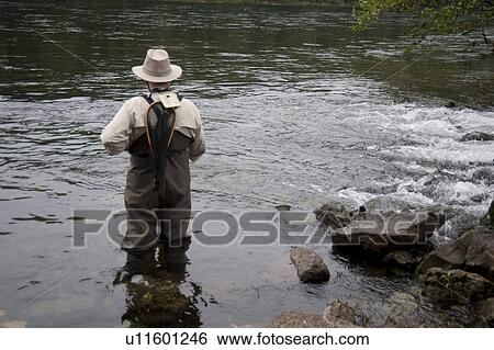 Stock Photograph - Man fly fishing at lake Taneycomo in Branson, Missouri. Fotosearch