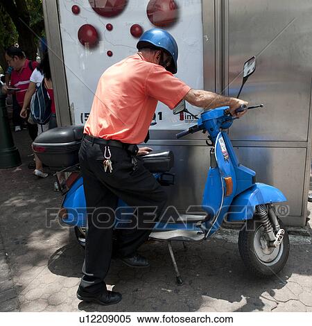 Man with a scooter on the streets of San Jose Costa Rica View Large Photo Image Stock Photography - Man with a scooter on the streets of San Jose Costa Rica. Fotosearch