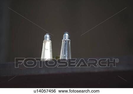 Stock Photograph - Metal and glass salt and pepper shakers. Fotosearch