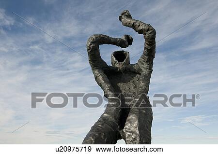 Stock Photo - Metal sculpture of figure shielding eyes from the sun. Fotosearch