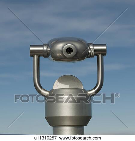 Stock Photo - Metalic binocular viewer in sky. Fotosearch