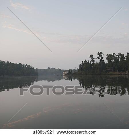 Stock Image - Misty sky over Lake of the Woods, Ontario. Fotosearch
