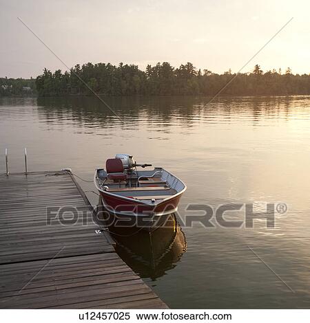 Motorboat at the dock in Lake of the Woods, Ontario View Large Photo Image Stock Photography - Motorboat at the dock in Lake of the Woods, Ontario. Fotosearch