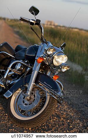Stock Photo - Motorcycle at the edge of a roadway. Fotosearch
