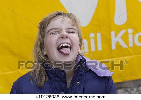 Nine year old girl sticking out her tongue in Vail, Colorado View Large Photo Image Stock Photograph - Nine year old girl sticking out her tongue in Vail, Colorado. Fotosearch