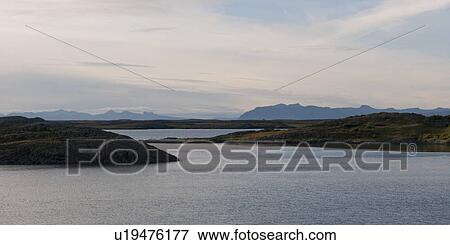 Stock Photo - Ocean and fjords looking towards misty mountains. Fotosearch