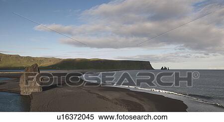 Stock Photography - Ocen waves on sandy spit near headland. Fotosearch