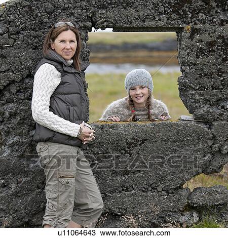 Portrait of a young girl through a rock wall window frame View Large Photo Image Stock Image - Portrait of a young girl through a rock wall window frame. Fotosearch