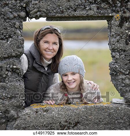Portrait of mother and daughter through distressed rock wall window frame View Large Photo Image Stock Photography - Portrait of mother and daughter through distressed rock wall window frame. Fotosearch