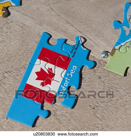 Stock Image - Puzzle pieces of the Canadian flag. Fotosearch