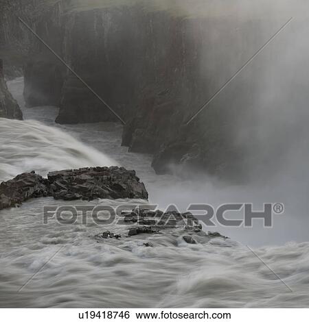 Stock Photograph - Raging waterfall over cliff. Fotosearch