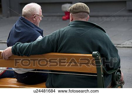 Picture - Rear view, two adult seniors on a park bench. Fotosearch