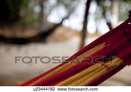 Red and yellow striped hammock detail with unfocused hammock in the background View Large Photo Image Stock Image - Red and yellow striped hammock detail with unfocused hammock in the background. Fotosearch
