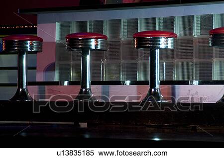 Stock Photography - Red bar stools in Branson, Missouri. Fotosearch
