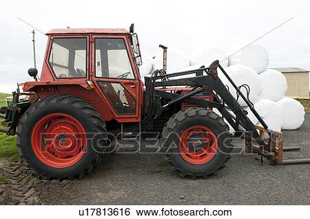 Red fork lift tractor with hay bales View Large Photo Image Stock Photograph - Red fork lift tractor with hay bales. Fotosearch
