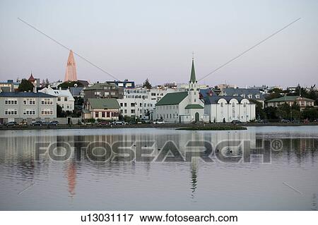Stock Photo - Reykjavik harbour, reflections of a church in the ocean water. Fotosearch