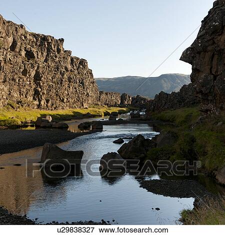 River in ravine below steep rocky cliffs View Large Photo Image Stock Photo - River in ravine below steep rocky cliffs. Fotosearch