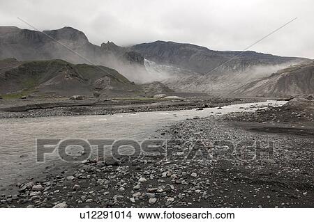Picture - Rugged mountain landscape with river and mist rising. Fotosearch