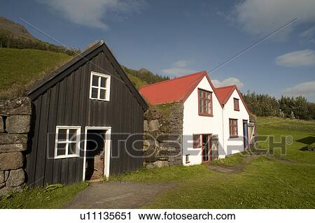 Stock Image - Rural farmyard with barn and houses . Fotosearch