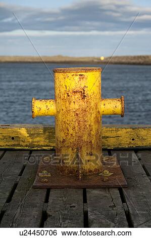 Stock Photograph - Rusted dock cleat in the Reykjanes Peninsula in Iceland. Fotosearch