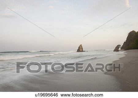 Stock Photograph - Seascape along Mal Pais coastline in San Jose Costa Rica. Fotosearch
