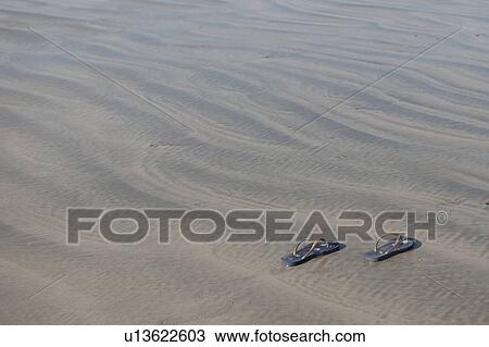 Stock Image - Shoes on sand. Fotosearch
