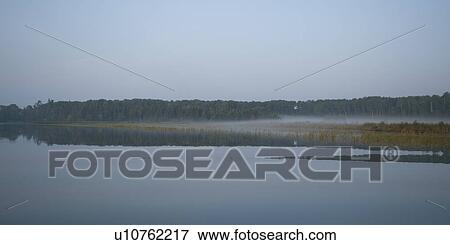 Stock Photo - Shoreline at twilight in Lake of the Woods, Ontario. Fotosearch
