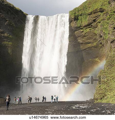 Sightseers at base of waterfall and rainbow View Large Photo Image Stock Photography - Sightseers at base of waterfall and rainbow. Fotosearch