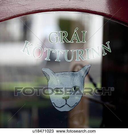 Stock Image - Signage painted on window with illustrations of a grey cat. Fotosearch