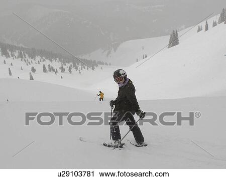 Stock Image - Skiing on a winter slope in Vail, Colorado. Fotosearch