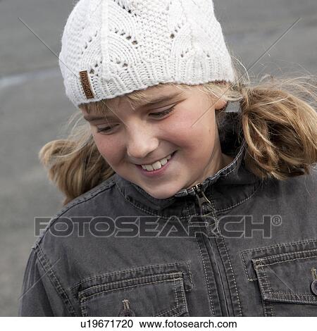 Smiling blond girl outside in woolen cap and demin jacket View Large Photo Image Stock Image - Smiling blond girl outside in woolen cap and demin jacket. Fotosearch
