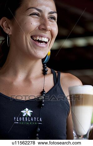 Stock Photo - Smiling female barista with a three layered coffee beverage. Fotosearch