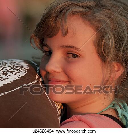 Picture - Smiling girl looking over her shoulder. Fotosearch