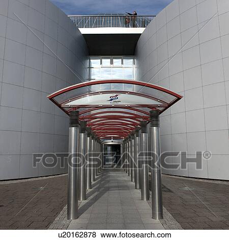 Stock Photo - Stainless steel columns, arched hallway to revolving door. Fotosearch