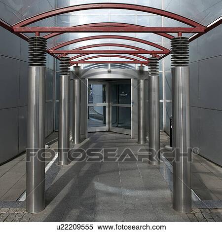 Stock Photography - Stainless steel columns, arched hallway to revolving door. Fotosearch