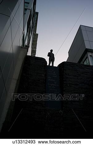 Stock Image - Statue amongst buildings in the city of Vancouver, British Columbia, Canada. Fotosearch