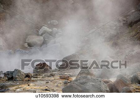 Stock Photo - Steam rising from boulders strewn landscape. Fotosearch