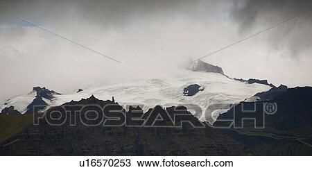 Stock Image - Stormy jagged mountain peak in a storm. Fotosearch