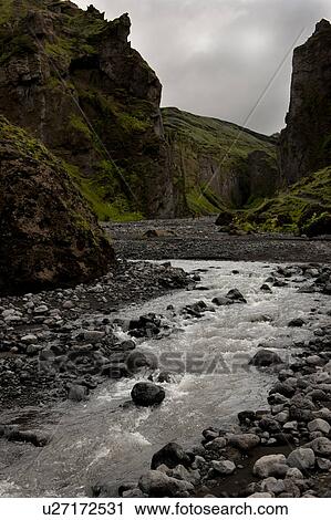 Stock Image - Stream at the bottom of a revine in Iceland. Fotosearch