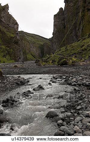 Stock Photo - Stream at the bottom of a revine in Iceland. Fotosearch
