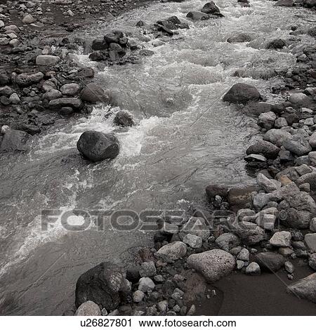 Stream flowing through rocky riverbed View Large Photo Image Stock Image - Stream flowing through rocky riverbed. Fotosearch