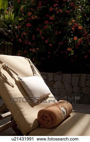 Stock Image - Sun lounger with a pillow and blanket. Fotosearch
