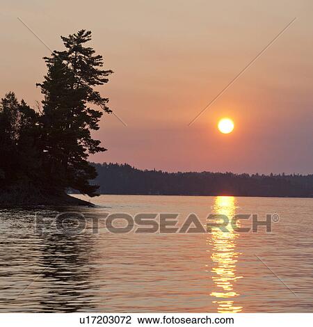 Stock Image - Sunset sky at Lake of the Woods, Ontario. Fotosearch